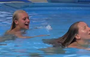Two beautiful girls swimming increased wits licking wits the pool
